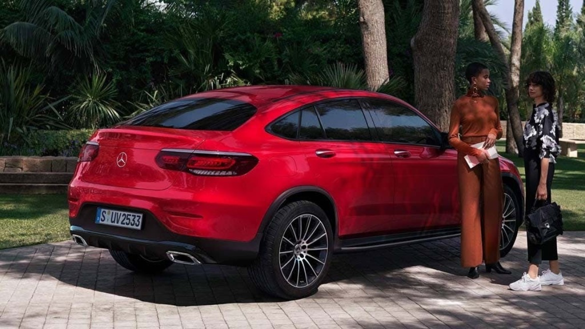 New Mercedes-Benz GLC Coupé in red parked under palm trees