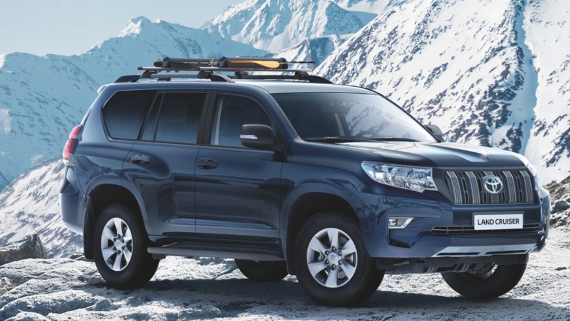 Toyota Land Cruiser parked on a snowy mountain