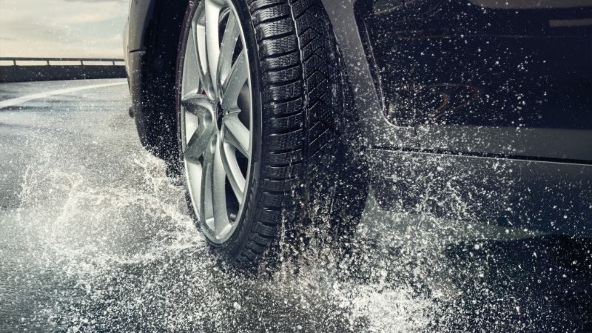 MINI tyre going through a puddle on the road