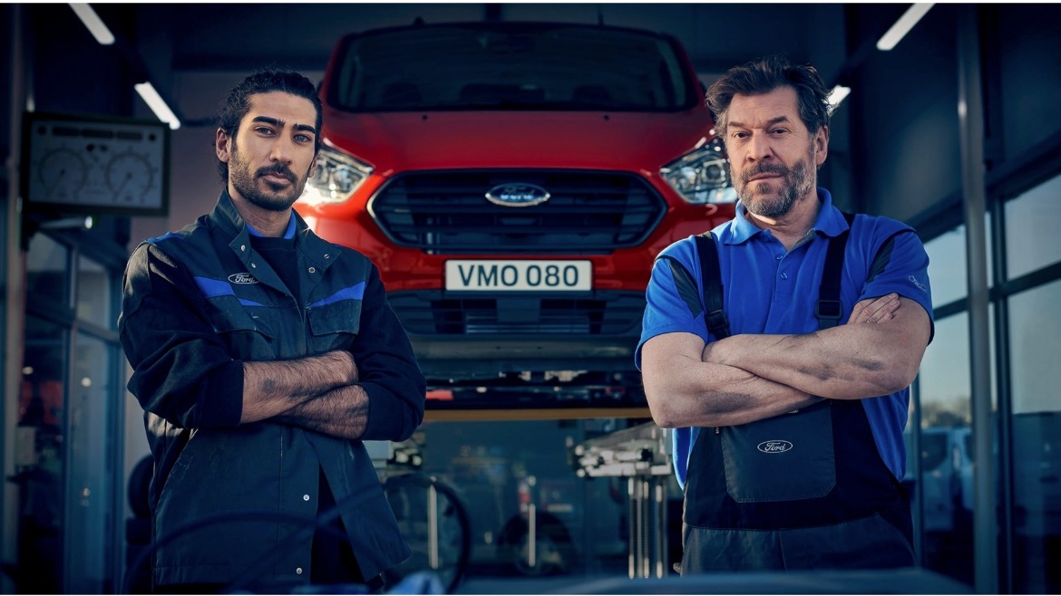 Ford service technicians standing in front of a red ford commercial vehicle