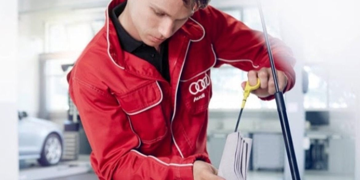 Audi technician checking the engine's oil levels
